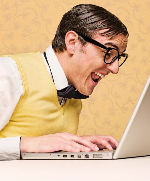 Young nerd sitting at the computer